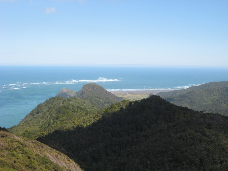 Sandbar at the entrance to the Manukau Harbour with waves breaking on it